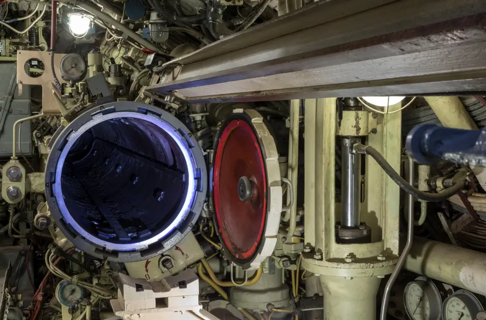US Navy nuclear propulsion plant operator working on reactor equipment aboard ship