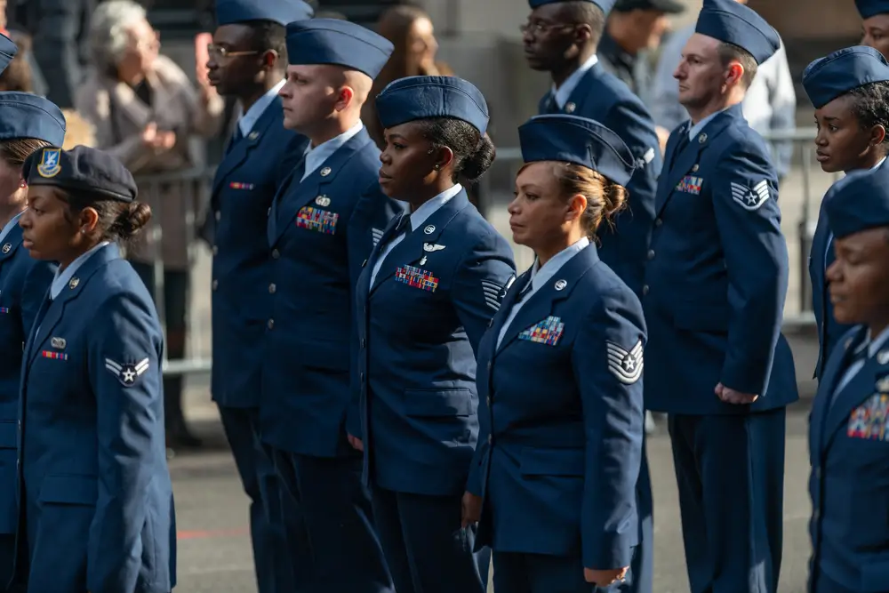 US Air Force airmen in blue military uniforms standing in formation at attention.