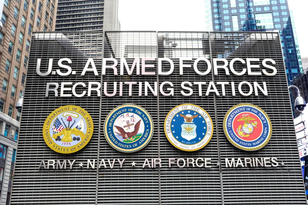 US Navy recruits in uniform standing at attention during enlistment processing