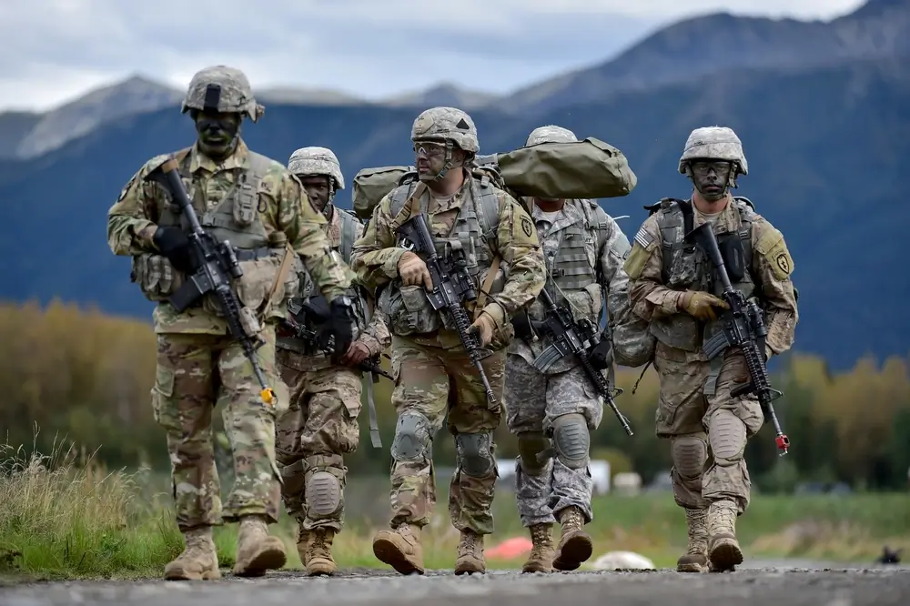 Infantry soldiers in full combat gear during an outdoor field training exercise
