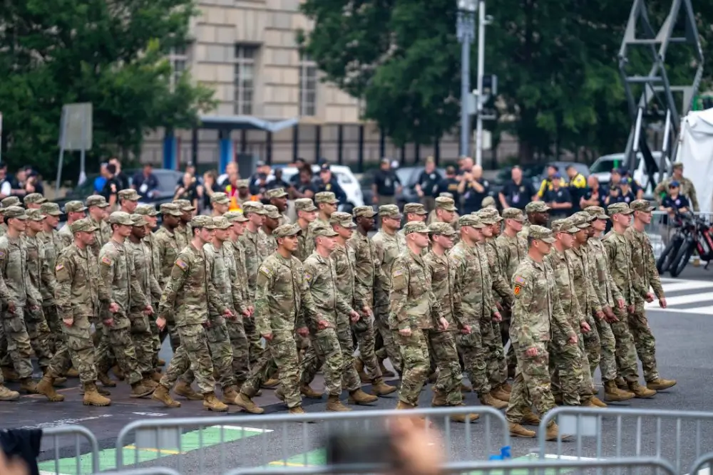 Army soldiers in uniform march in a military parade ceremony, reflecting the diverse career paths available to recruits.