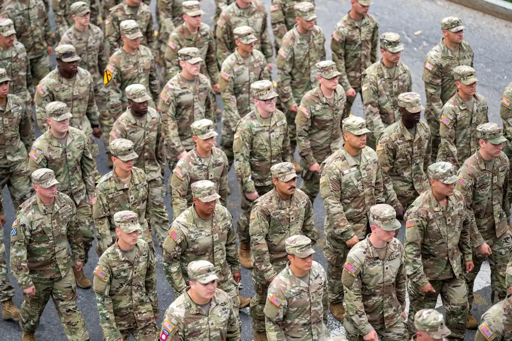 Soldiers in uniform lined up during military branch selection ceremony outdoors