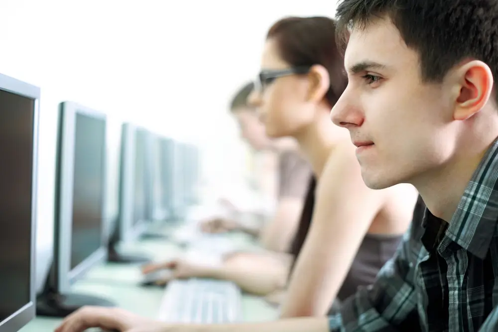 Students seated at computers taking a timed test in a classroom