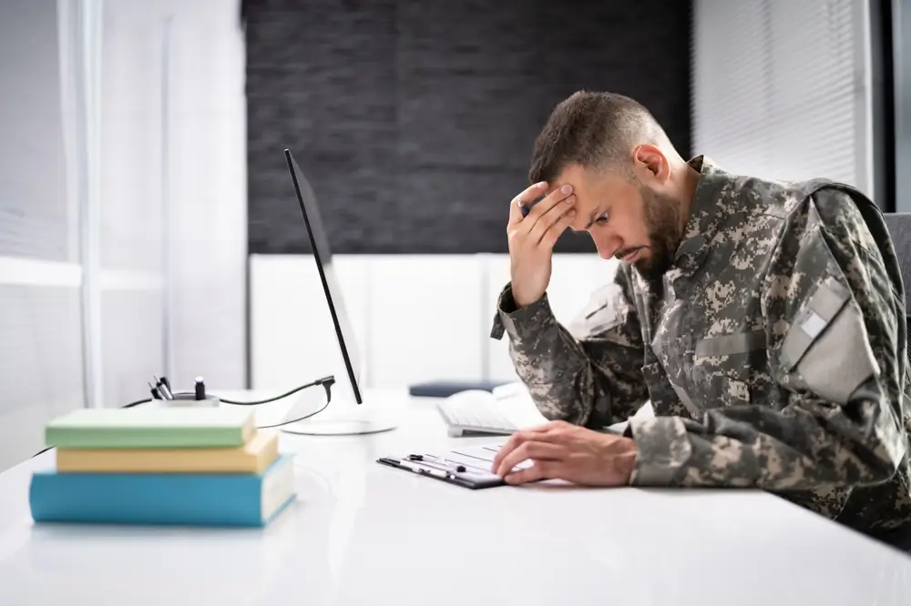 Military recruits standing at attention in uniform during enlistment processing