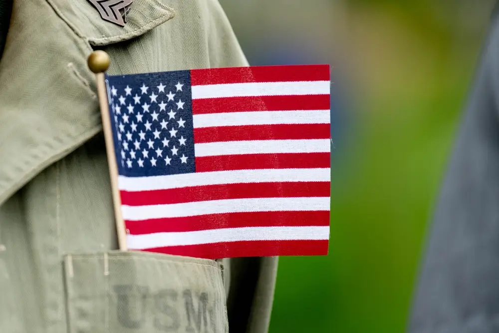 Military recruiter in uniform speaking with a civilian at an enlistment office