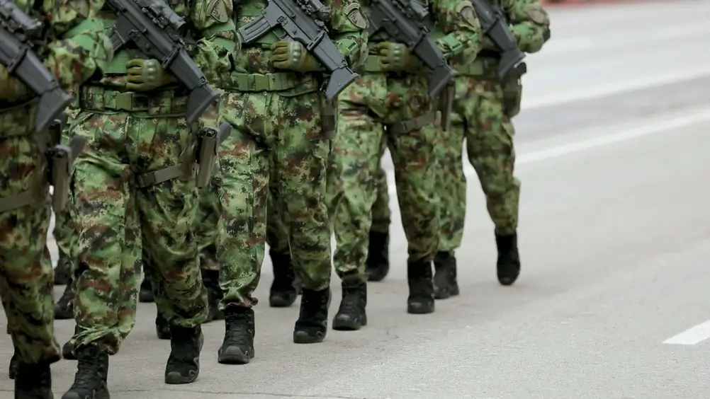 Soldiers in uniform standing at attention during military training formation