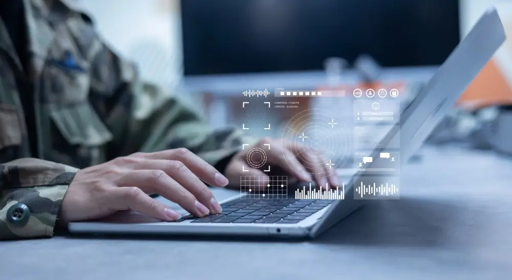 Military recruit in uniform taking a computer test on a laptop with digital data overlays.